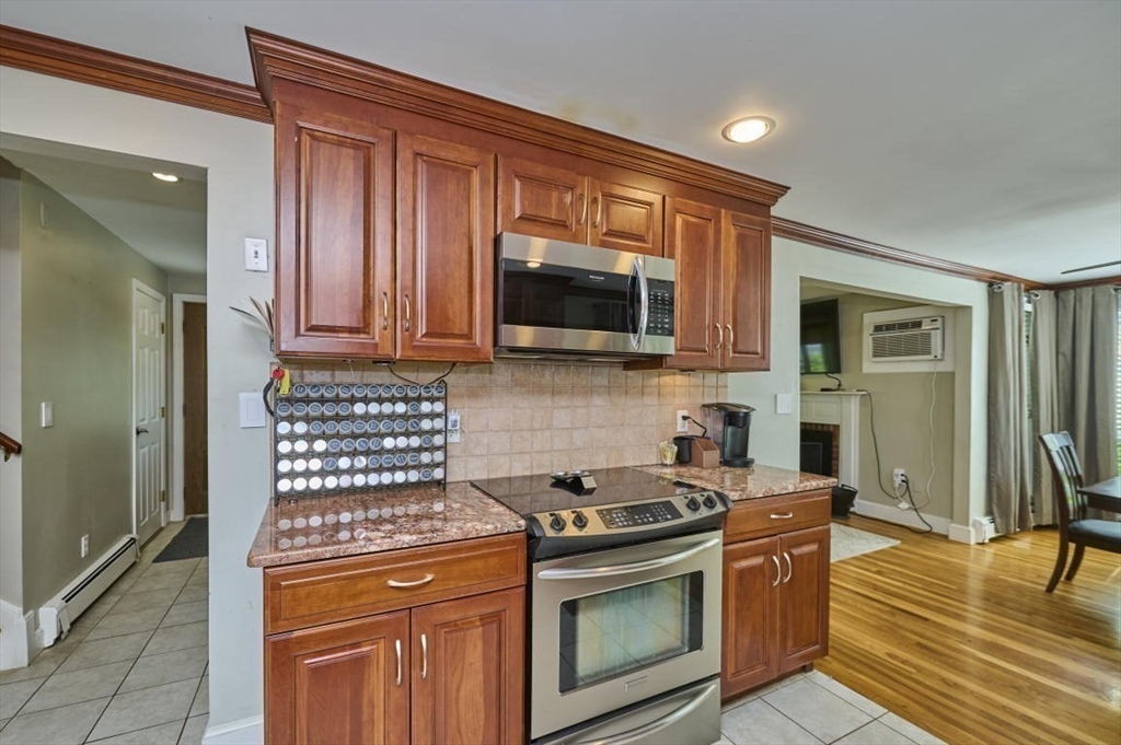 7 Lasallette Road Billerica, MA 01821 - Photo 9 of 35 a kitchen with stainless steel appliances granite countertop a stove microwave and refrigerator