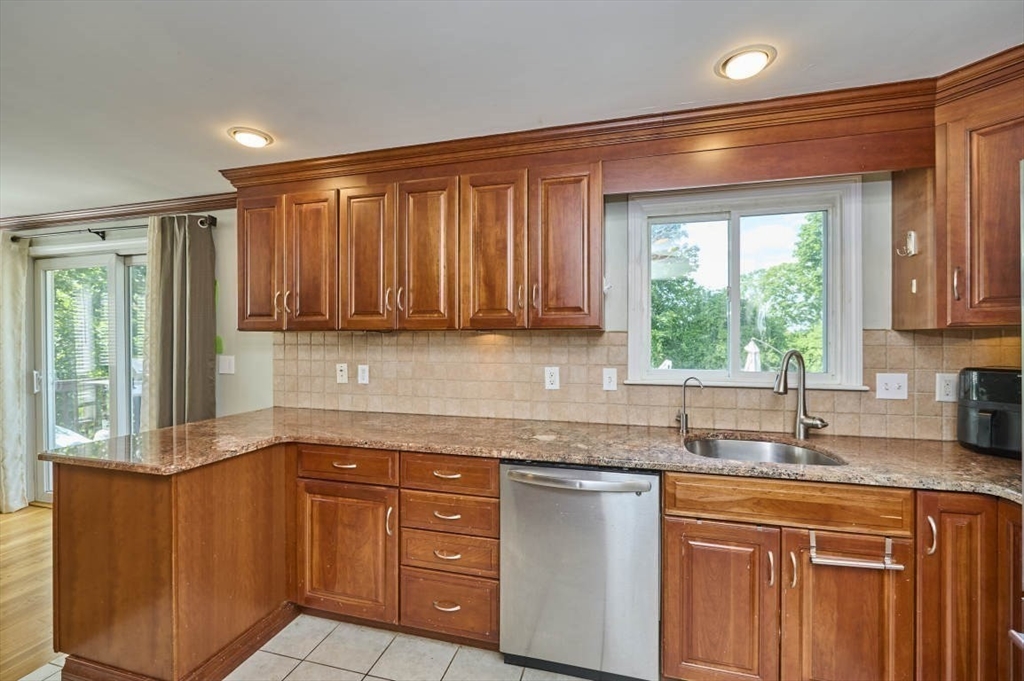 7 Lasallette Road Billerica, MA 01821 - Photo 10 of 35 a kitchen with granite countertop wooden cabinets a sink and a window