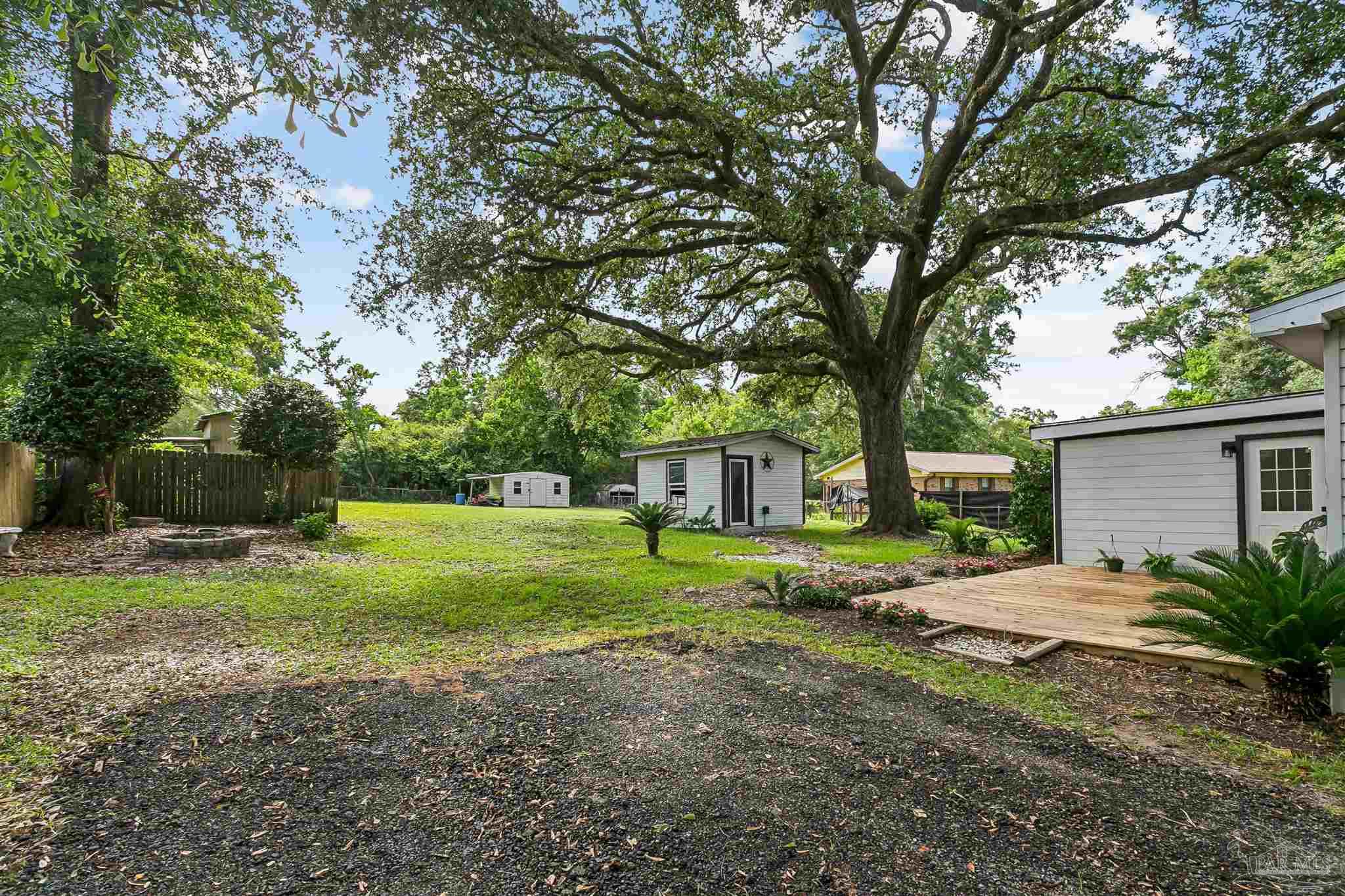1095 River Annex Road Cantonment, FL 32533 - Photo 25 of 32 a view of a house with backyard and trees