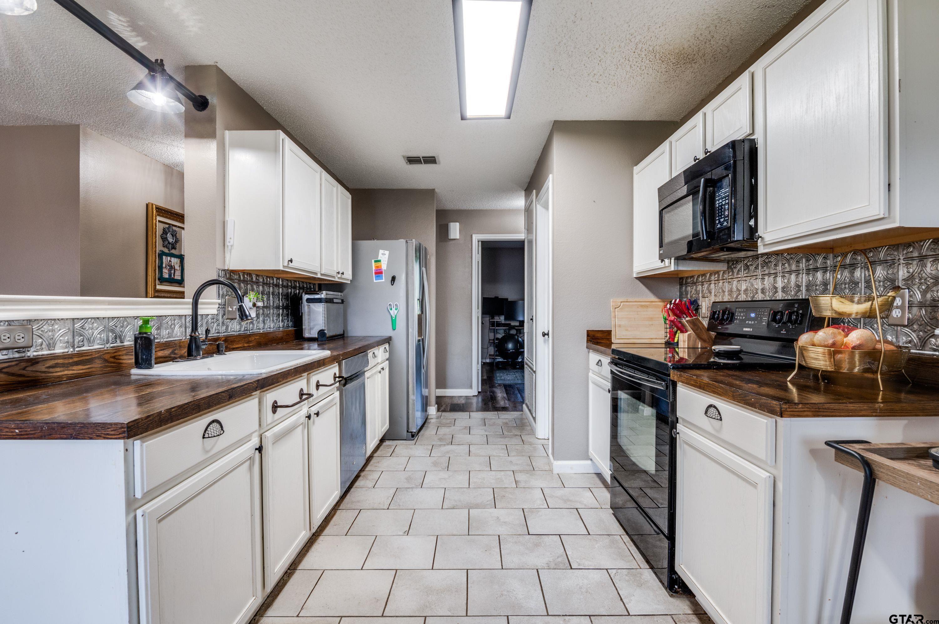 2748 Cameron Way Mesquite, TX 75181 - Photo 12 of 25 a kitchen with stainless steel appliances granite countertop a stove a sink and a refrigerator