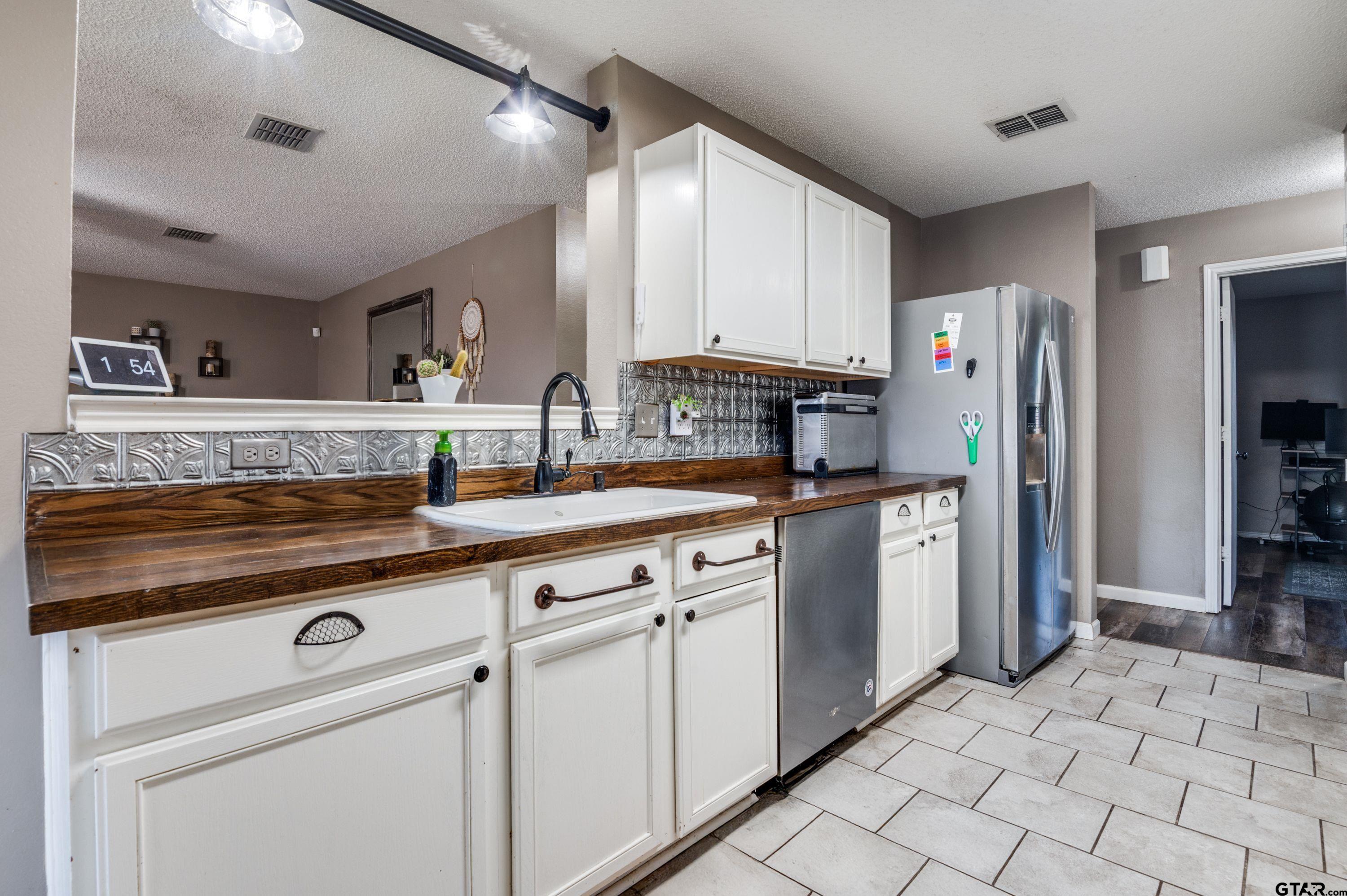 2748 Cameron Way Mesquite, TX 75181 - Photo 10 of 25 a kitchen with stainless steel appliances granite countertop a refrigerator and a sink