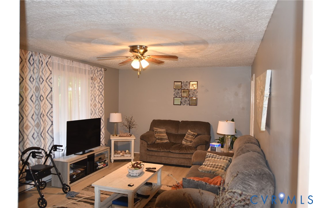 642 Star Street Pounding Mill, VA 24637 - Photo 8 of 20 Living area featuring light-toned walls, a ceiling
