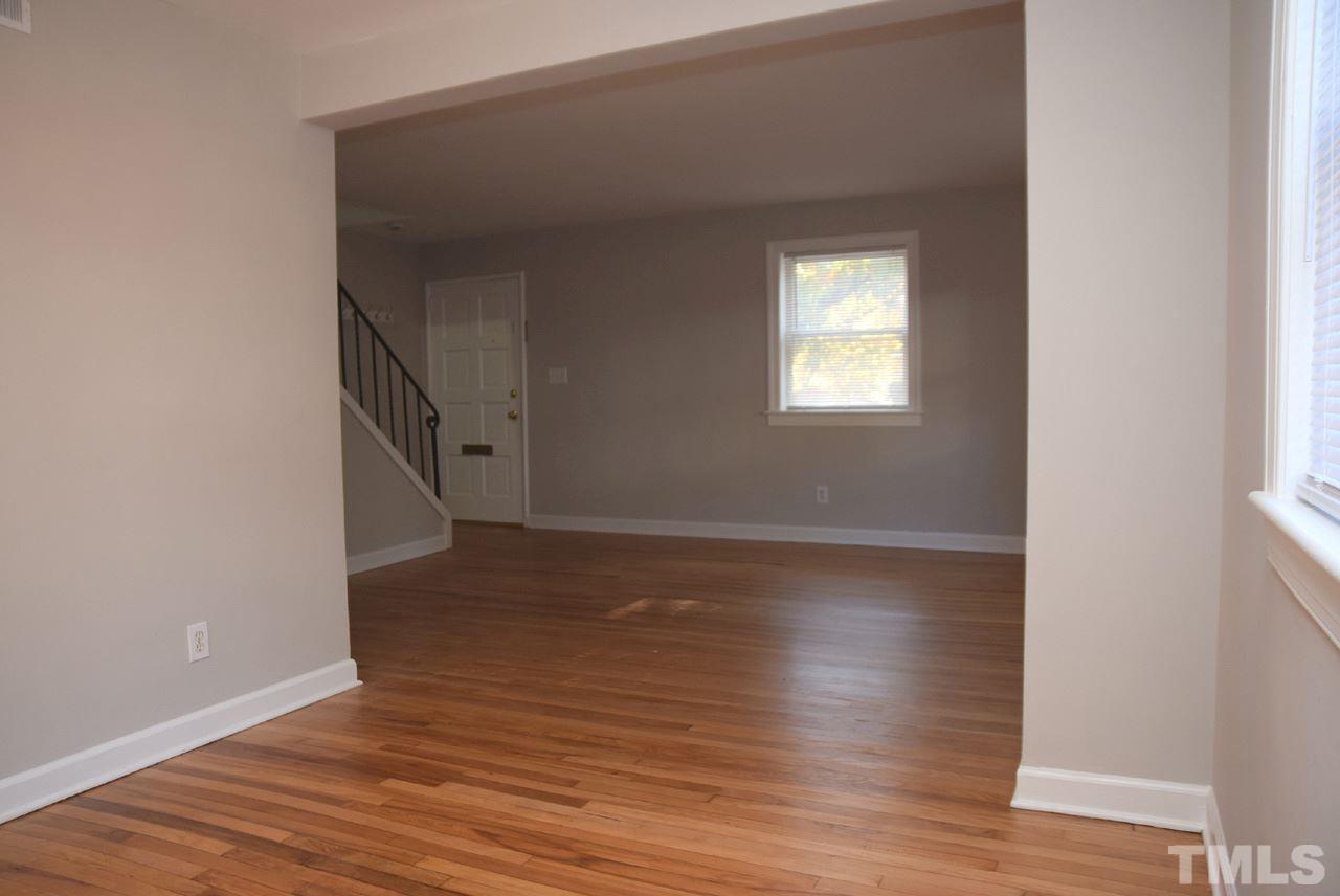 1057 Nichols Drive Raleigh, NC 27605 - Photo 12 of 39 a view of an empty room with wooden floor and a window
