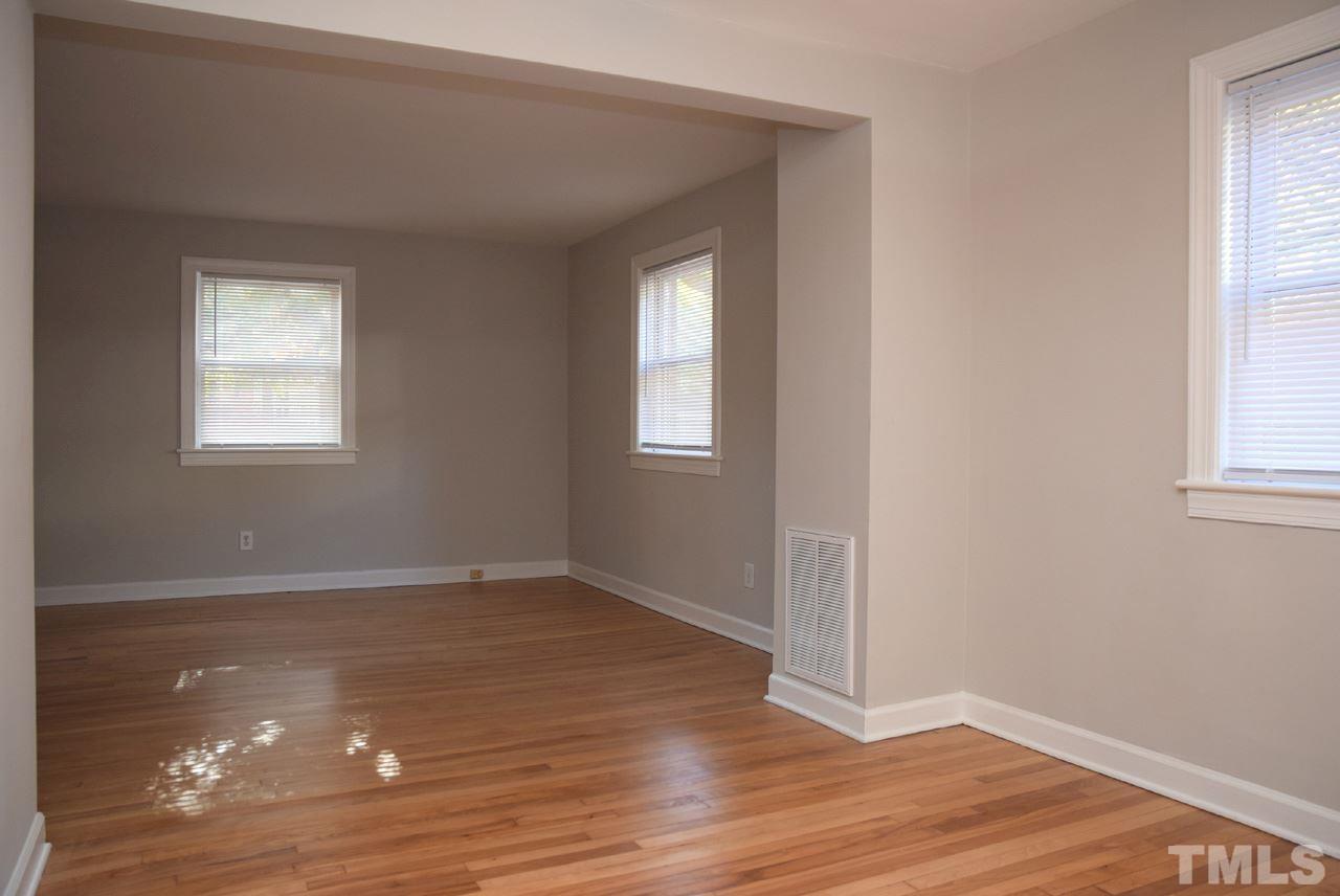 1057 Nichols Drive Raleigh, NC 27605 - Photo 13 of 39 an empty room with wooden floor and windows