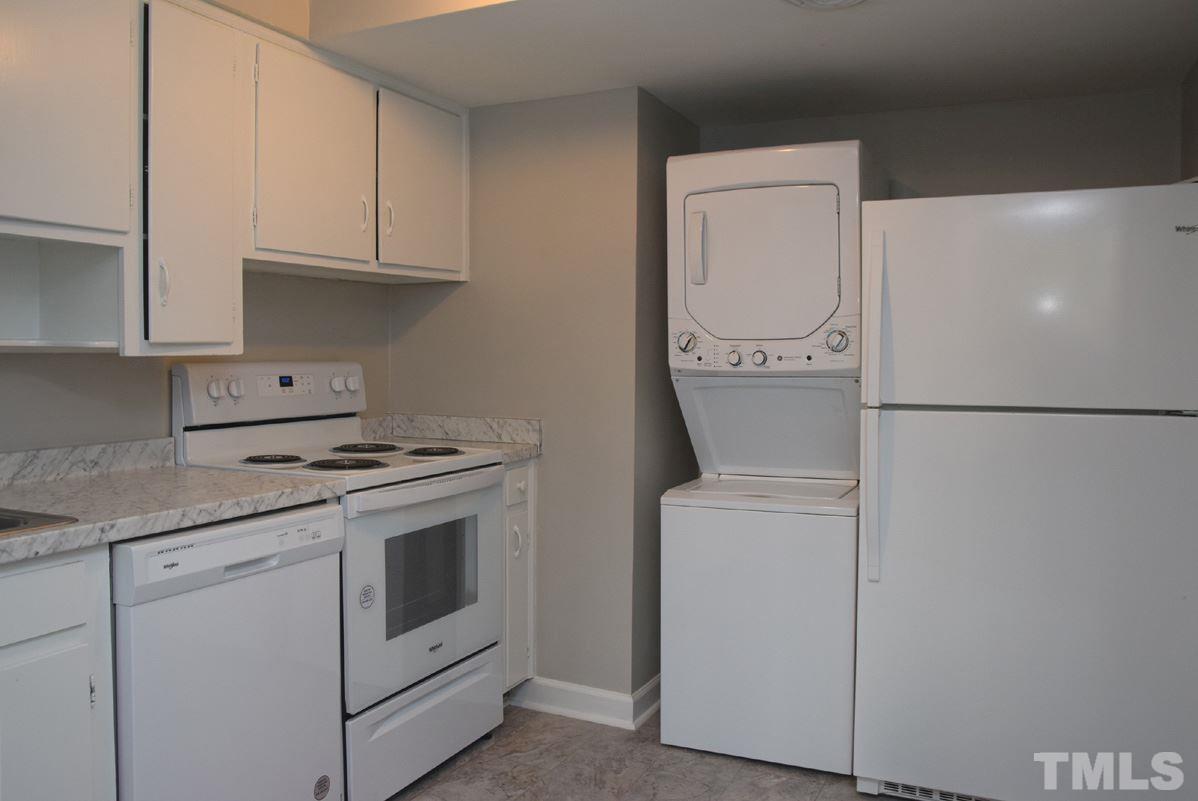 1057 Nichols Drive Raleigh, NC 27605 - Photo 15 of 39 a kitchen with stainless steel appliances white cabinets and a refrigerator