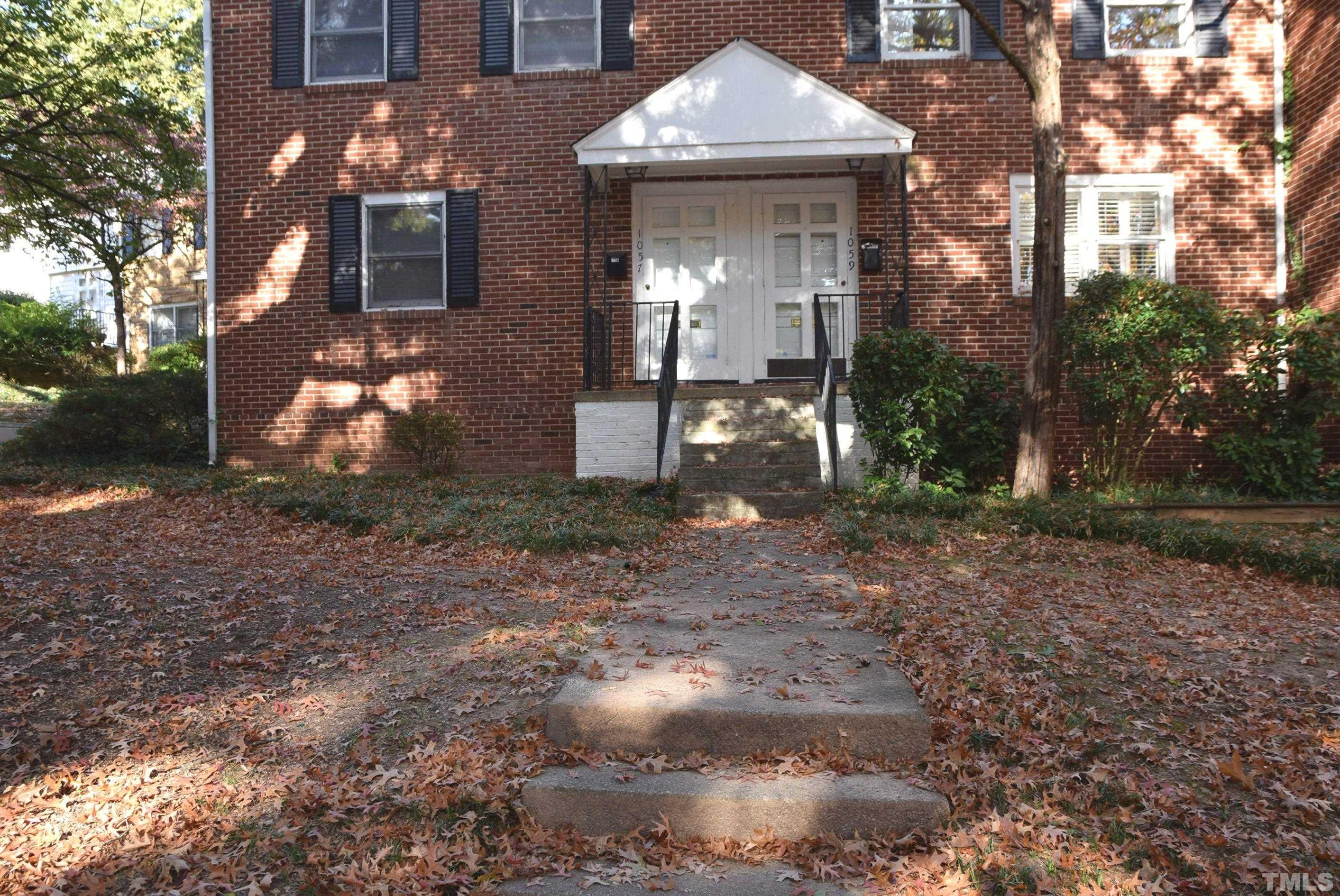 1057 Nichols Drive Raleigh, NC 27605 - Photo 2 of 39 a view of a brick house next to a yard