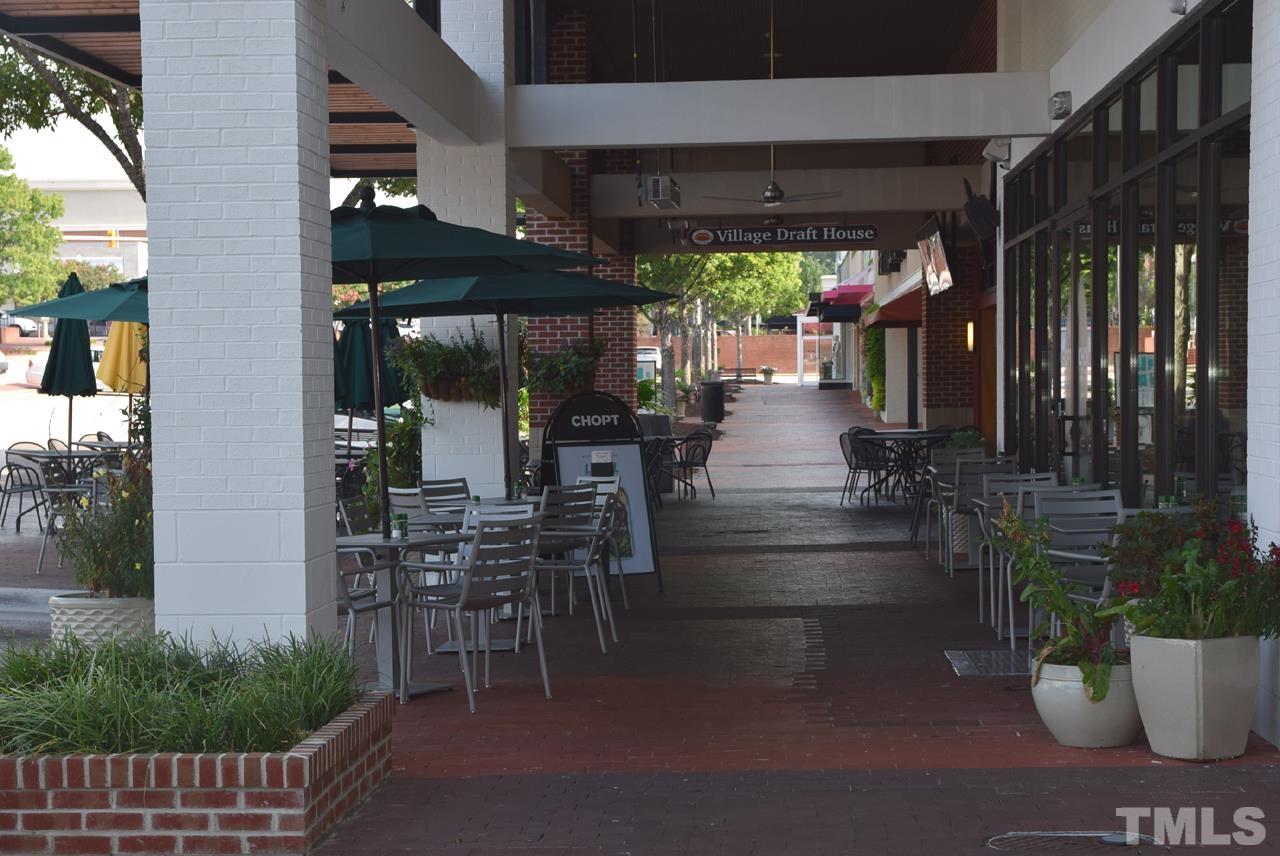 1057 Nichols Drive Raleigh, NC 27605 - Photo 29 of 39 a view of a patio with table and chairs potted plants