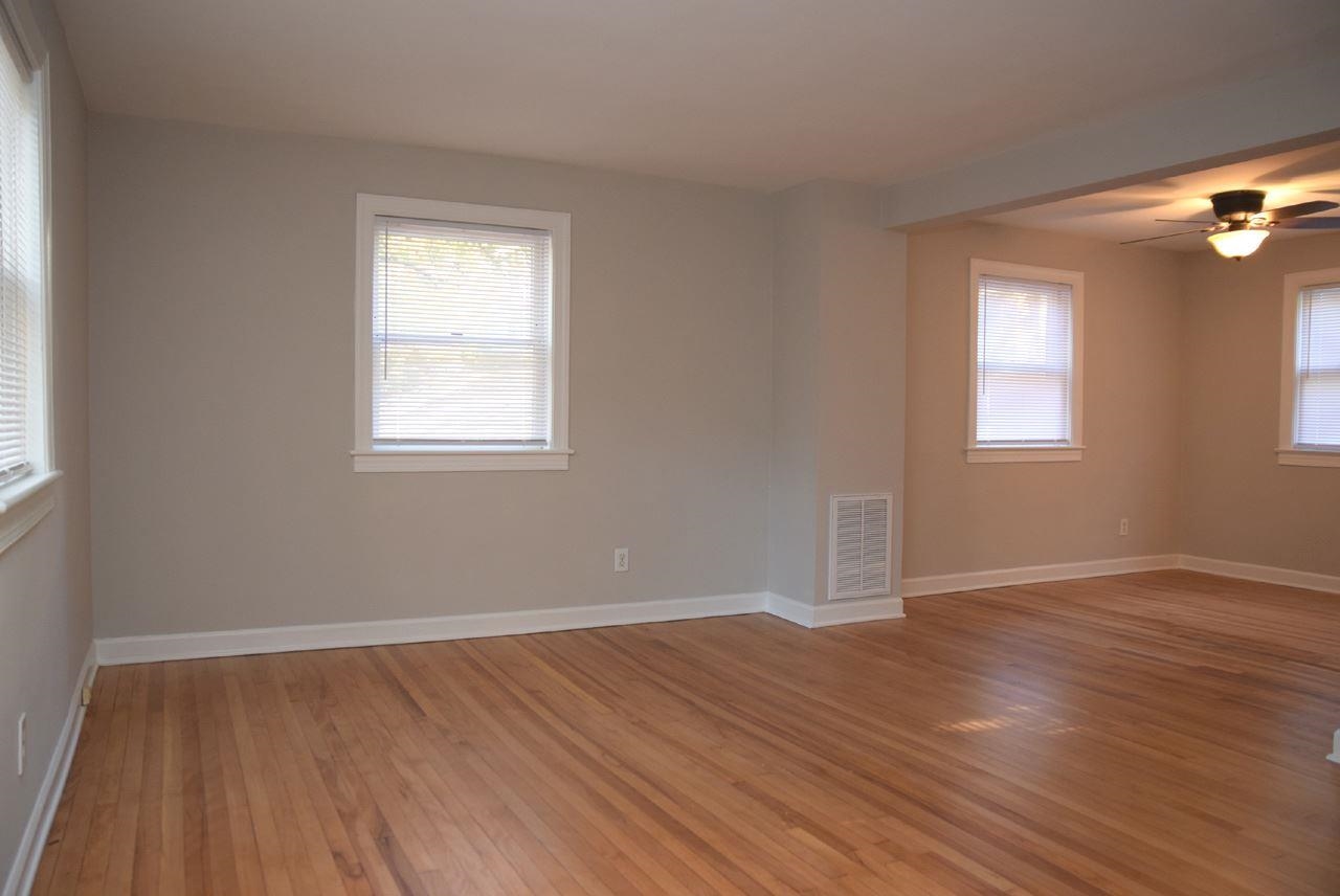 1057 Nichols Drive Raleigh, NC 27605 - Photo 3 of 39 an empty room with wooden floor and windows
