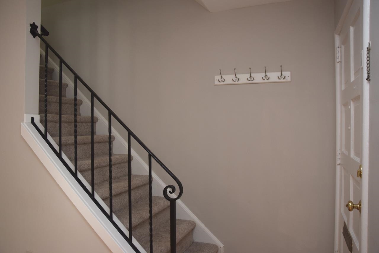 1057 Nichols Drive Raleigh, NC 27605 - Photo 6 of 39 a view of a hallway with wooden floor and stairs