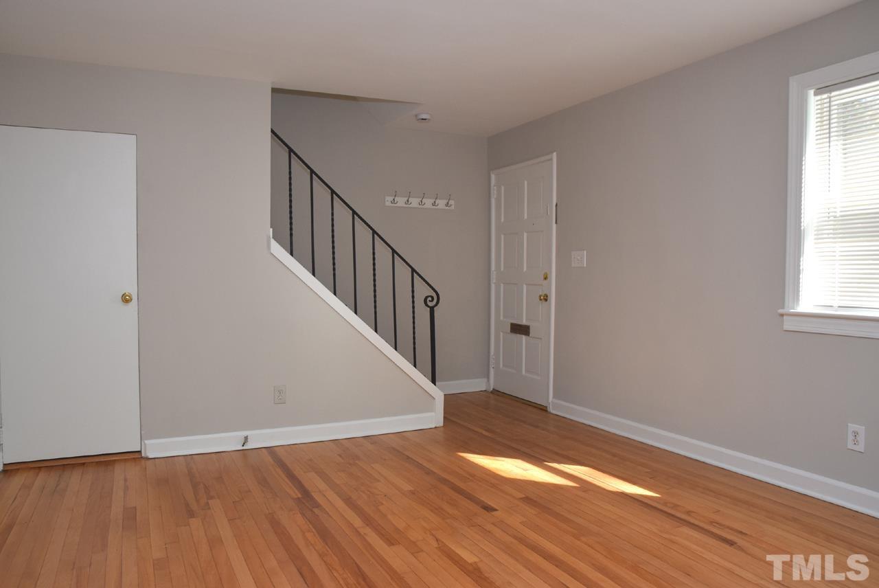 1057 Nichols Drive Raleigh, NC 27605 - Photo 7 of 39 a view of empty room with wooden floor and fan