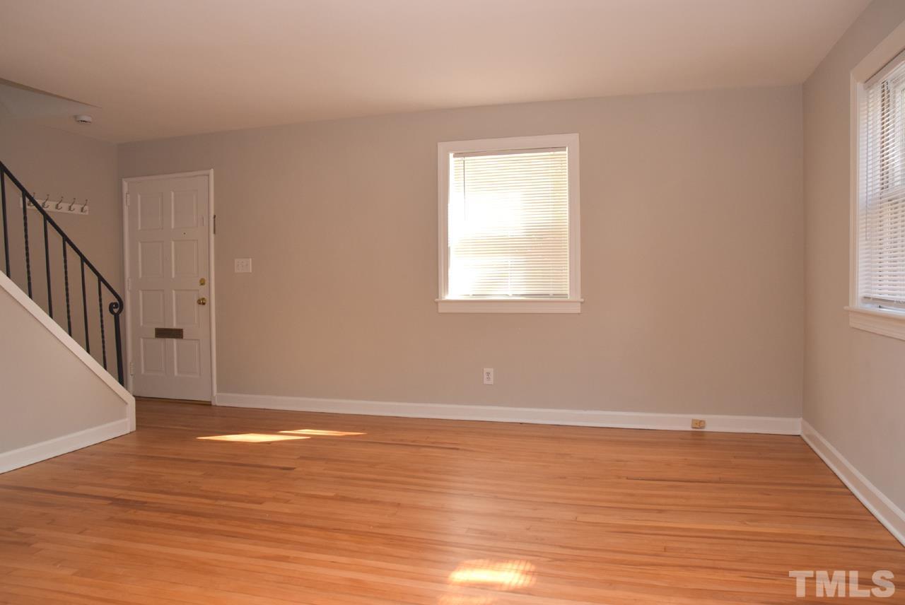 1057 Nichols Drive Raleigh, NC 27605 - Photo 8 of 39 a view of an empty room with wooden floor and a window