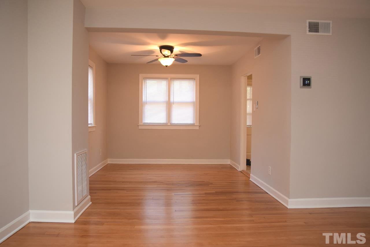 1057 Nichols Drive Raleigh, NC 27605 - Photo 10 of 39 wooden floor in an empty room with a window