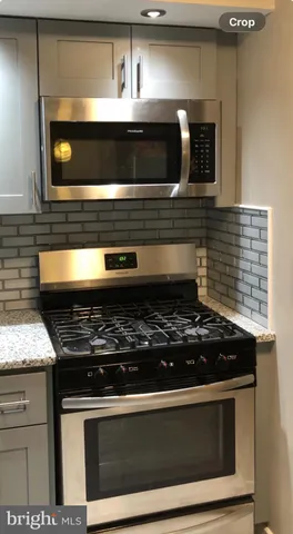 a stove top oven sitting inside of a kitchen