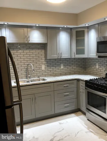 a kitchen with stainless steel appliances granite countertop a sink and a stove