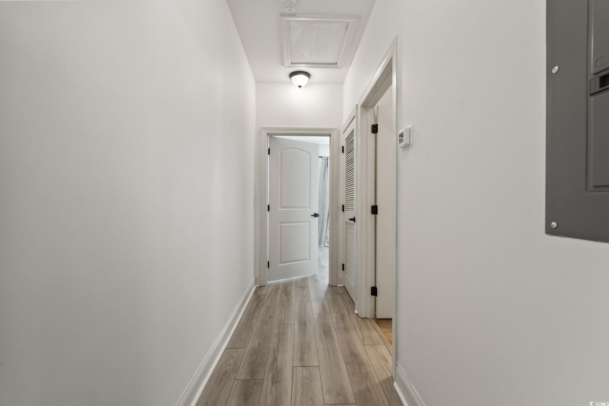 118 Ella Kinley Circle, Unit 404 Myrtle Beach, SC 29588 - Photo 16 of 22 Corridor featuring light wood-style floors and electric panel