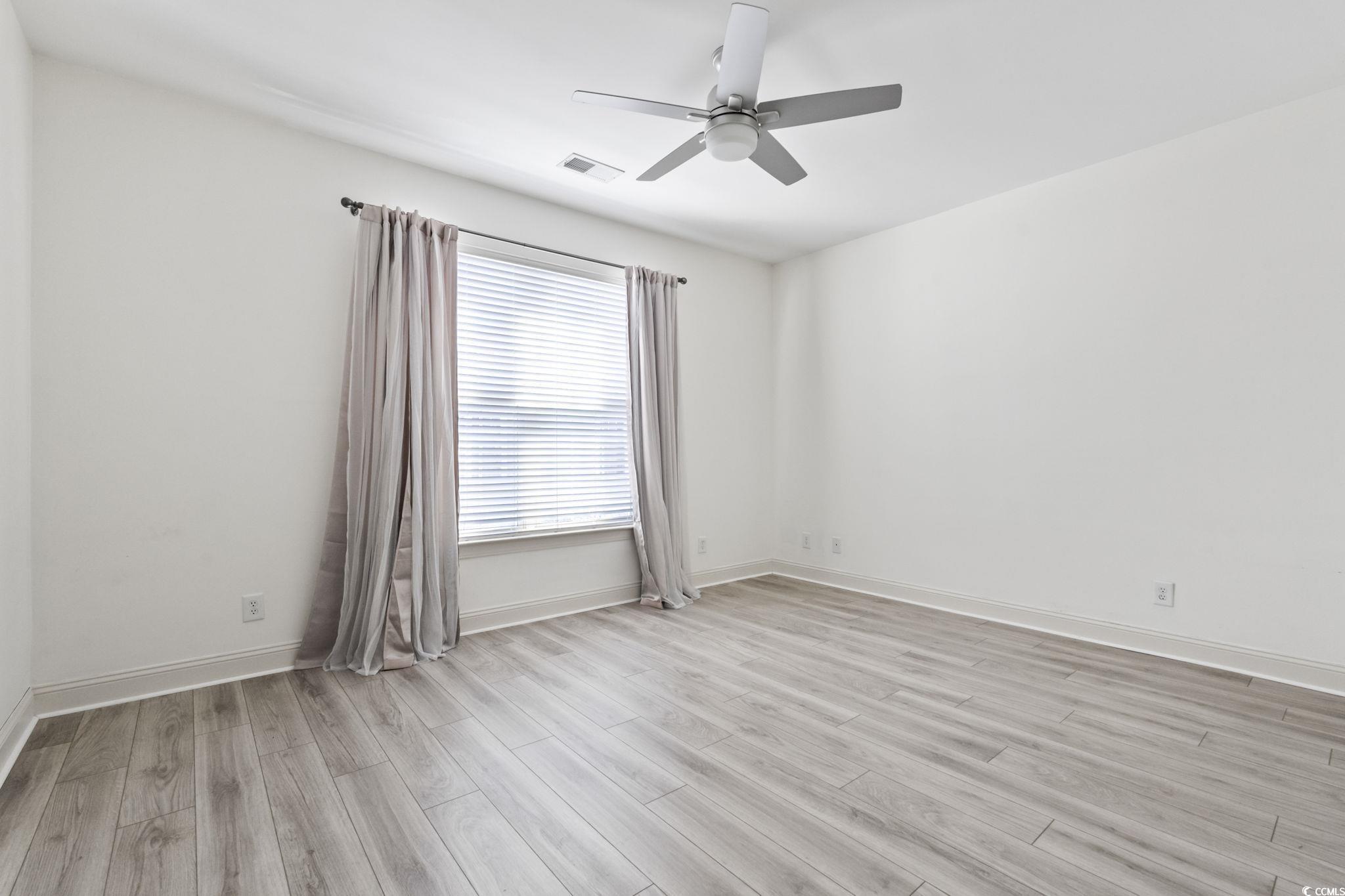 118 Ella Kinley Circle, Unit 404 Myrtle Beach, SC 29588 - Photo 17 of 22 Unfurnished room featuring light wood-style floors and a ceiling fan