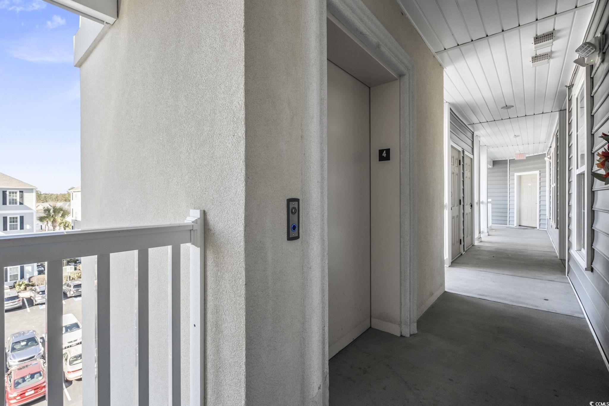 118 Ella Kinley Circle, Unit 404 Myrtle Beach, SC 29588 - Photo 20 of 22 Hallway featuring elevator
