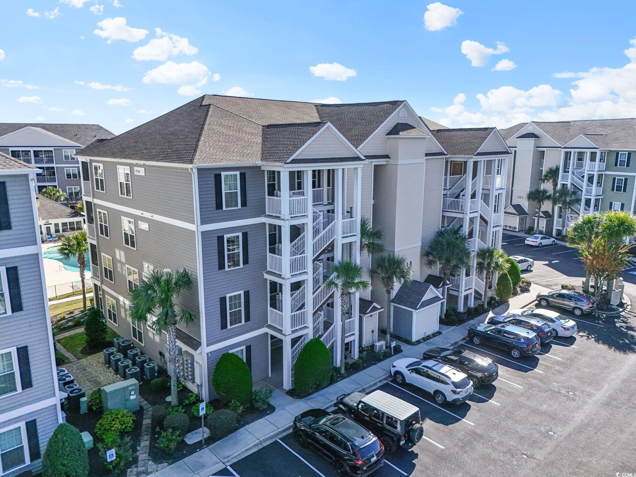 118 Ella Kinley Circle, Unit 404 Myrtle Beach, SC 29588 - Photo 21 of 22 View of apartment building / complex with uncovered parking