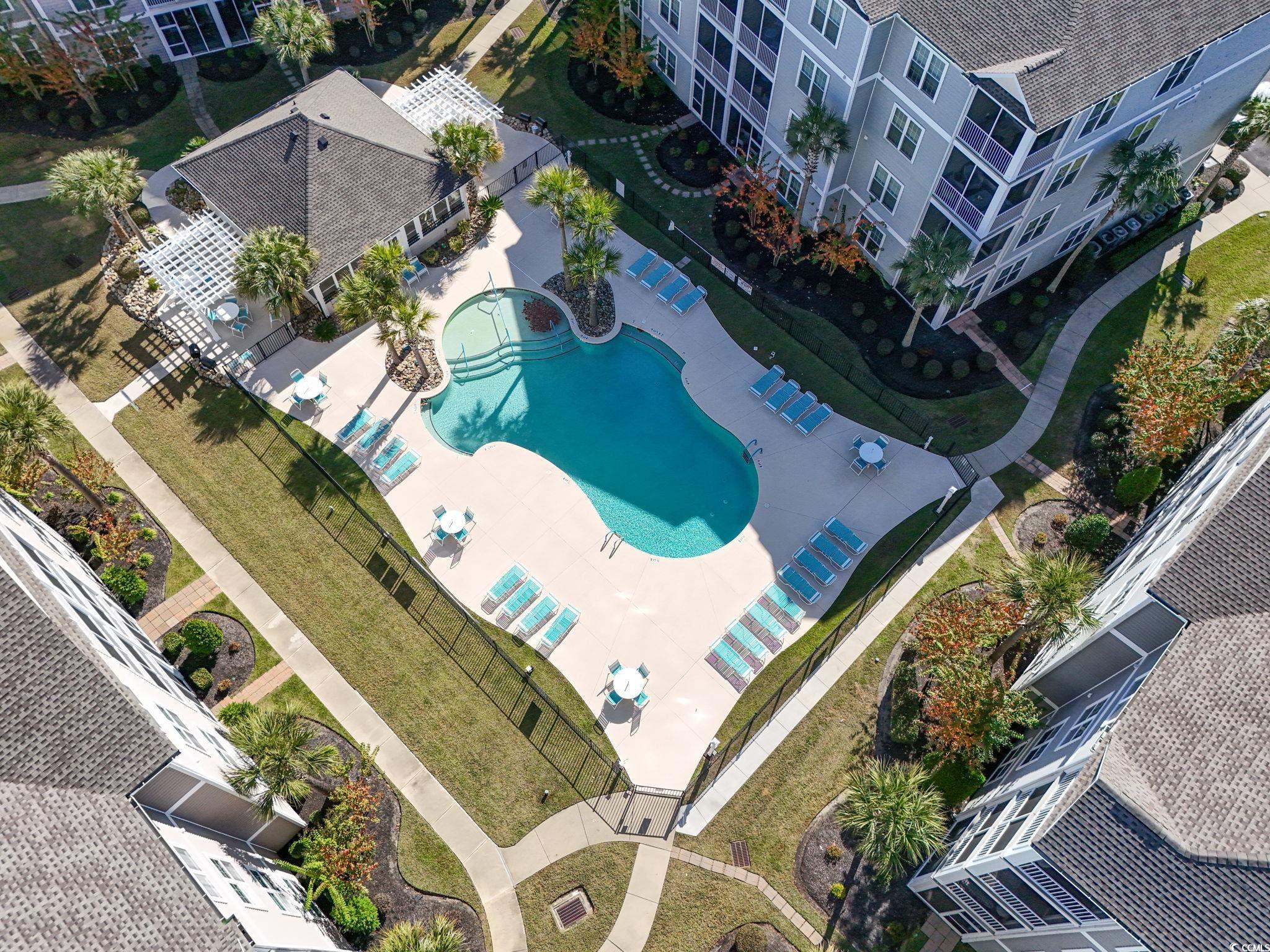 118 Ella Kinley Circle, Unit 404 Myrtle Beach, SC 29588 - Photo 4 of 22 Aerial view of a pool area and apartment complex / building