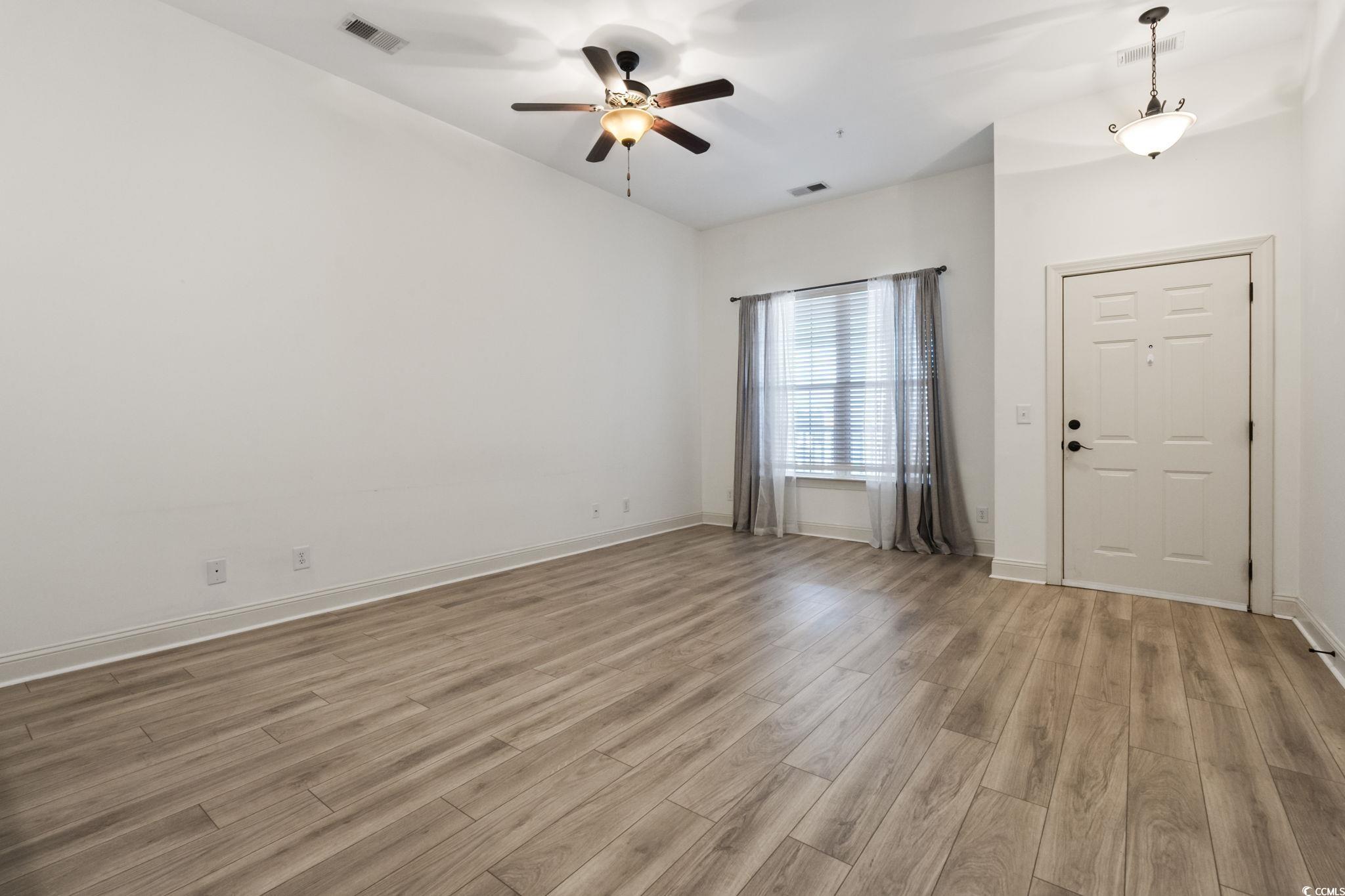 118 Ella Kinley Circle, Unit 404 Myrtle Beach, SC 29588 - Photo 6 of 22 Spare room featuring light wood-type flooring and a ceiling fan