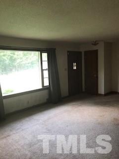 3716 Buffaloe Road Raleigh, NC 27604 - Photo 4 of 10 a view of an empty room with a window