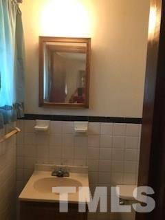 3716 Buffaloe Road Raleigh, NC 27604 - Photo 6 of 10 a bathroom with a sink and a mirror