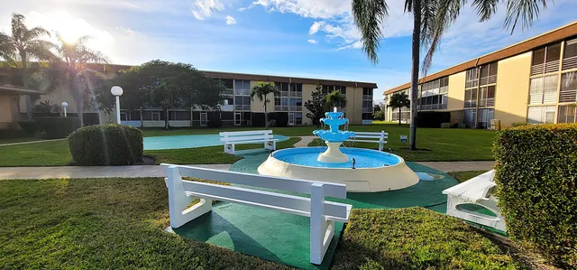 a house view with a sitting space and garden