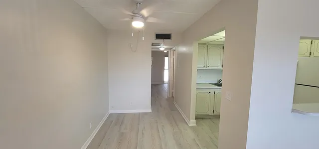 a view of a hallway with wooden shelves