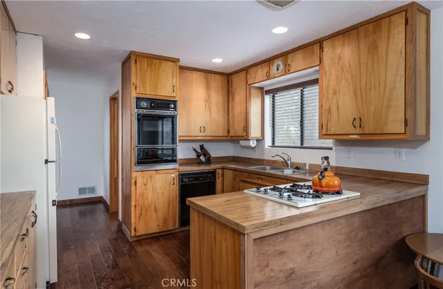 a kitchen with a sink stove and refrigerator
