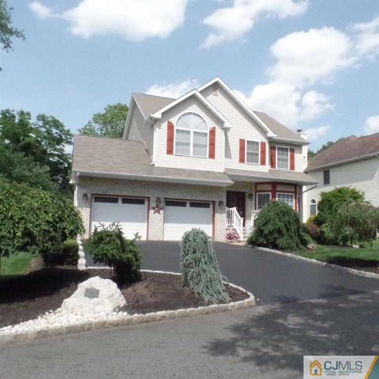 130 Dover Road Colonia, NJ 07067 - Photo 1 of 23 a front view of a house with a yard and garage