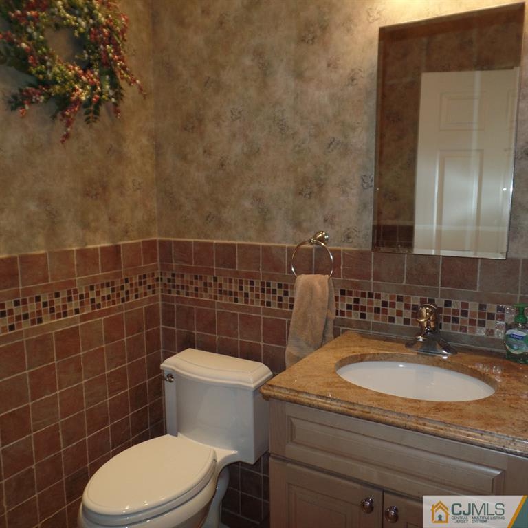 130 Dover Road Colonia, NJ 07067 - Photo 11 of 23 a bathroom with a sink a toilet and a mirror
