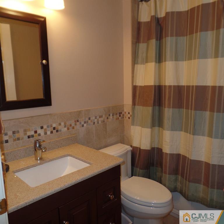 130 Dover Road Colonia, NJ 07067 - Photo 20 of 23 a bathroom with a sink a toilet and shower