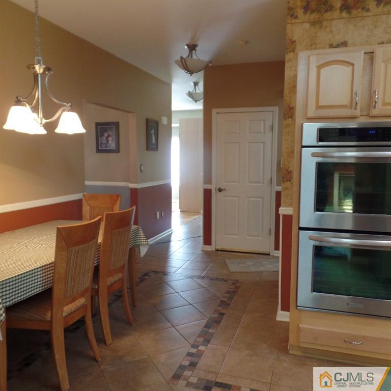 130 Dover Road Colonia, NJ 07067 - Photo 9 of 23 a dining room with furniture and a fireplace