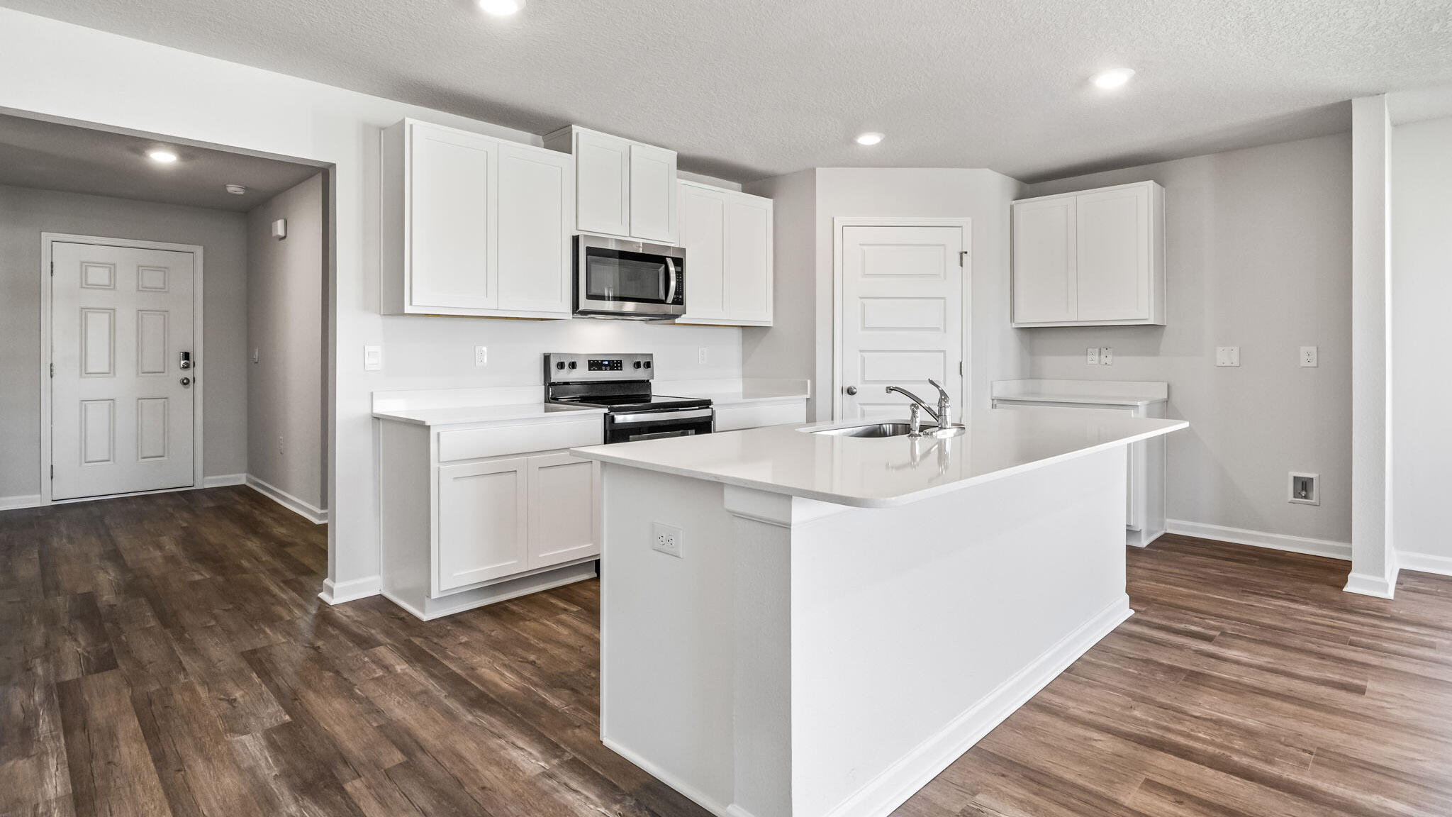 51 Foxtrail Run Freeport, FL 32439 - Photo 4 of 21 a white kitchen with wooden floor and white stainless steel appliances