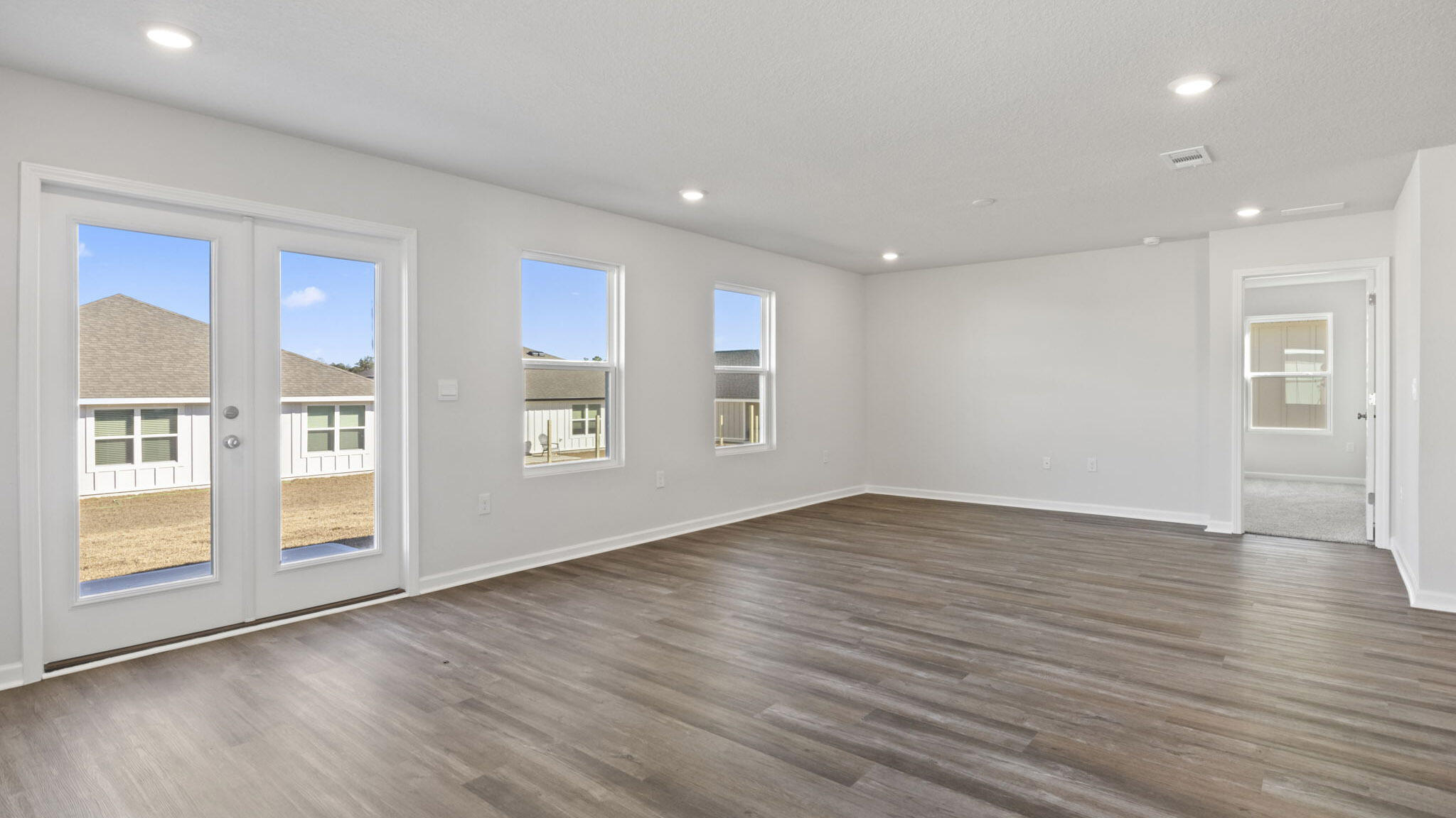 51 Foxtrail Run Freeport, FL 32439 - Photo 8 of 21 a view of an empty room with glass door and wooden floor