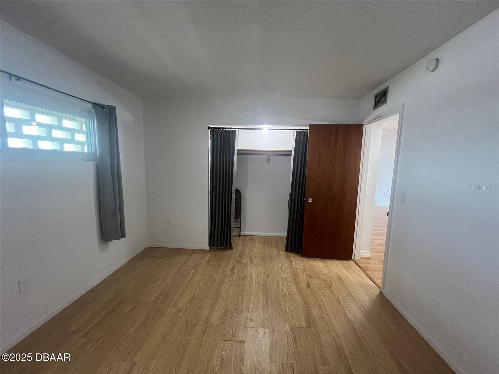 2711 North Halifax Avenue, Unit 593 Daytona Beach, FL 32118 - Photo 15 of 42 a view of empty room with wooden floor