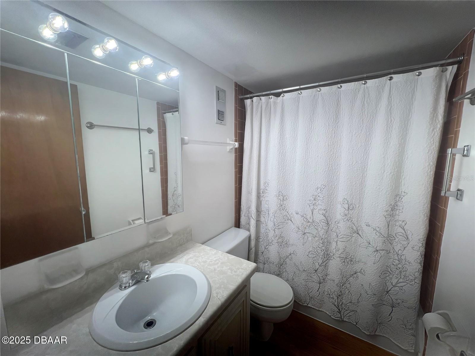 2711 North Halifax Avenue, Unit 593 Daytona Beach, FL 32118 - Photo 16 of 42 a bathroom with a sink toilet and shower