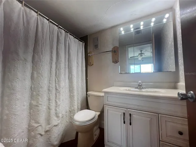 a large bedroom with a bed and a large window