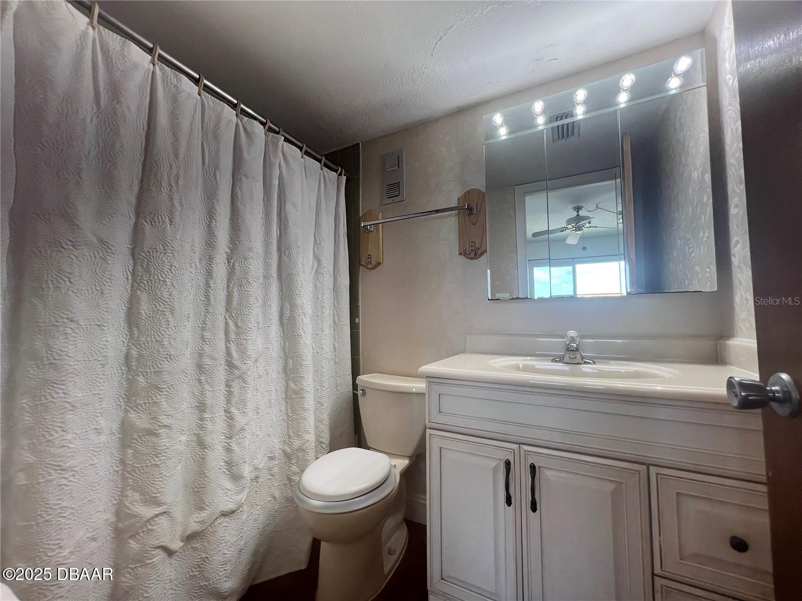 2711 North Halifax Avenue, Unit 593 Daytona Beach, FL 32118 - Photo 22 of 42 a bathroom with a sink a toilet and shower