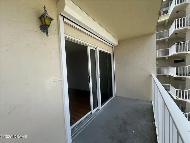 a view of a patio with table and chairs potted plants