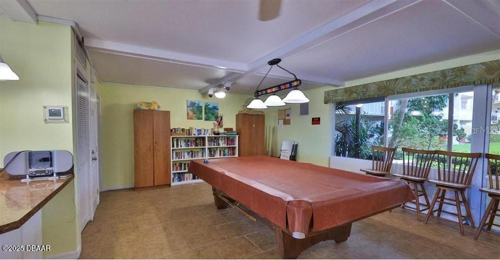 2711 North Halifax Avenue, Unit 593 Daytona Beach, FL 32118 - Photo 32 of 42 a large bedroom with a bed and a large window