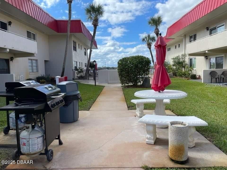 2711 North Halifax Avenue, Unit 593 Daytona Beach, FL 32118 - Photo 36 of 42 a view of a patio with table and chairs potted plants