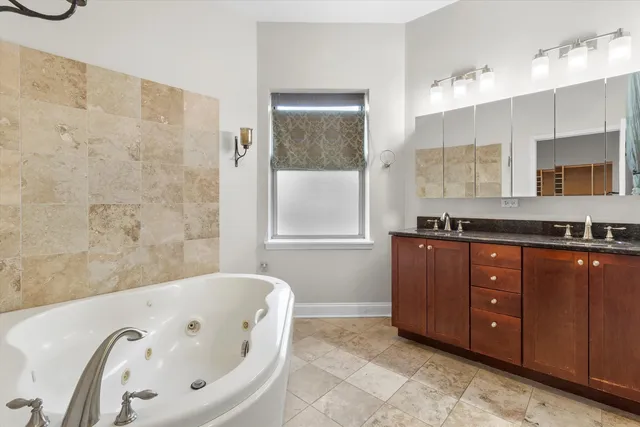 a bathroom with a granite countertop sink toilet and mirror