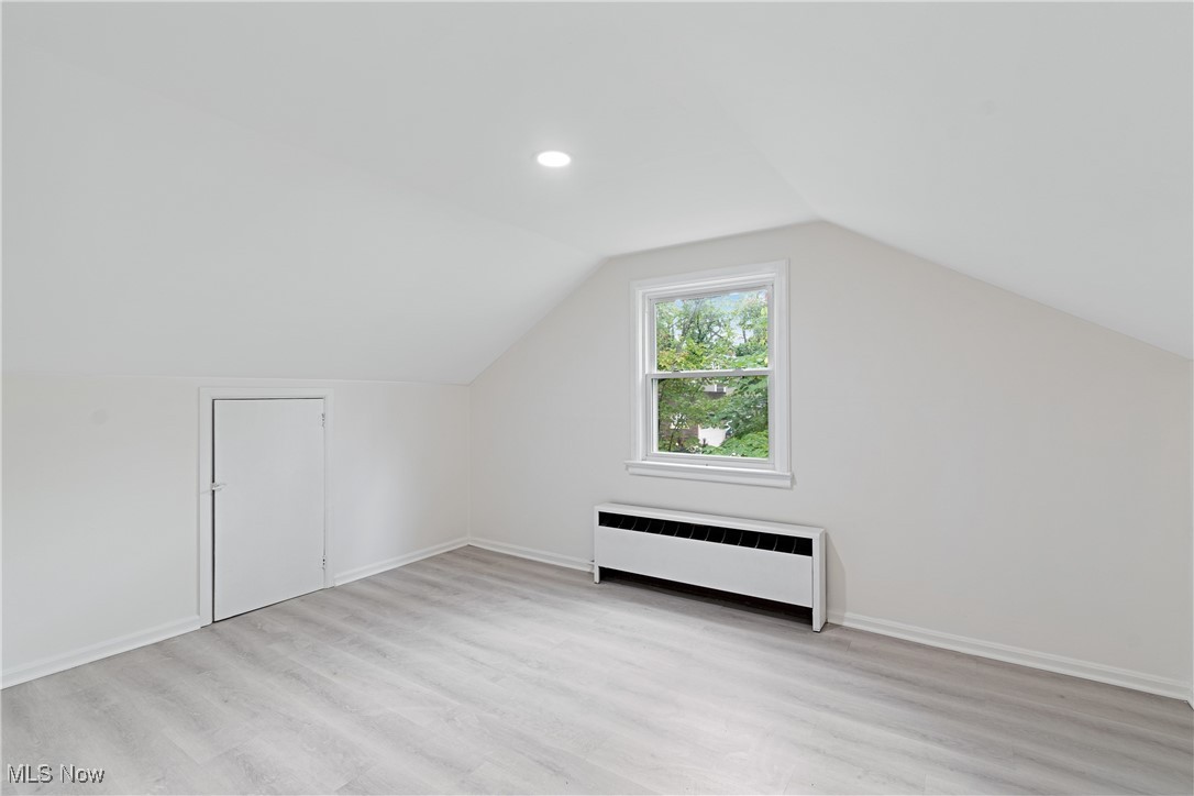 1057 Renfield Road Cleveland Heights, OH 44121 - Photo 24 of 30 Bonus room with radiator, vaulted ceiling, and light hardwood / wood-style floors