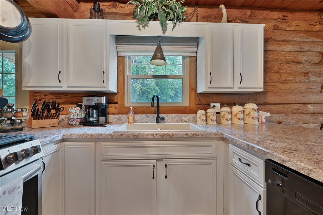 14 Clingan Road Struthers, OH 44471 - Photo 13 of 50 Kitchen featuring white cabinetry, stainless steel range with gas stovetop, and black dishwasher