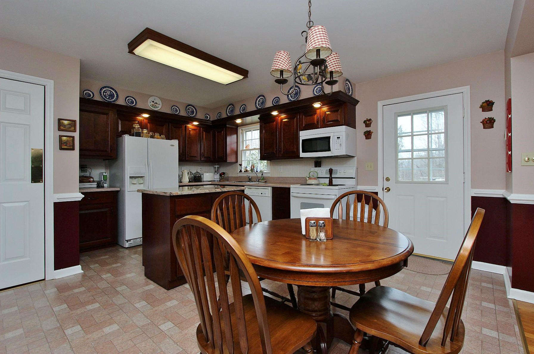 1131 Quarles Road Thaxton, VA 24174 - Photo 23 of 58 a kitchen with sink refrigerator dining table and chairs