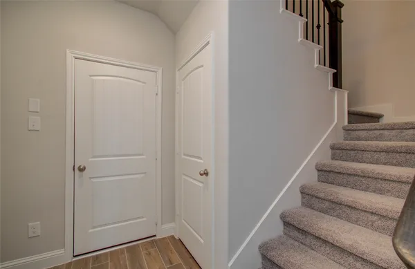 an empty room with a window and a chandelier fan