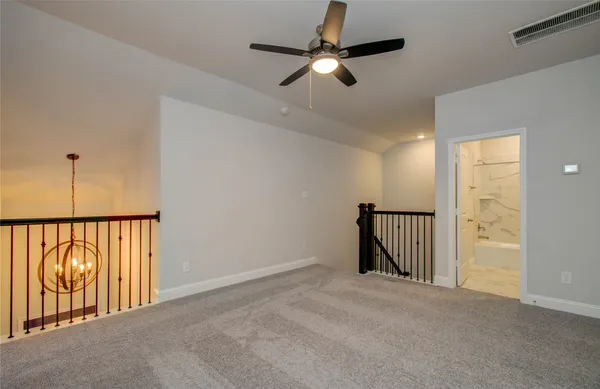 a bathroom with a granite countertop toilet a sink a mirror and a window