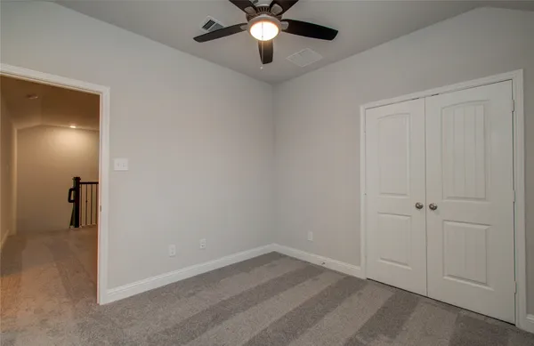 a view of a house with a yard and pathway