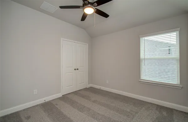 a front view of a house with a garden and plants